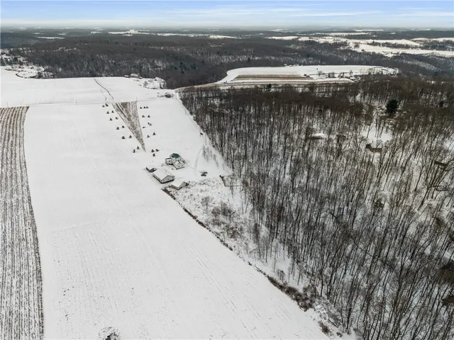 a large kitchen with stainless steel appliances granite countertop a stove a sink dishwasher a refrigerator and white cabinets with wooden floor