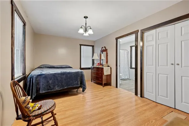 a bedroom with a large bed and a window