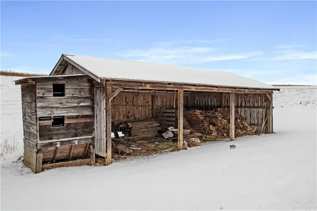 a view of ocean with snow on beach