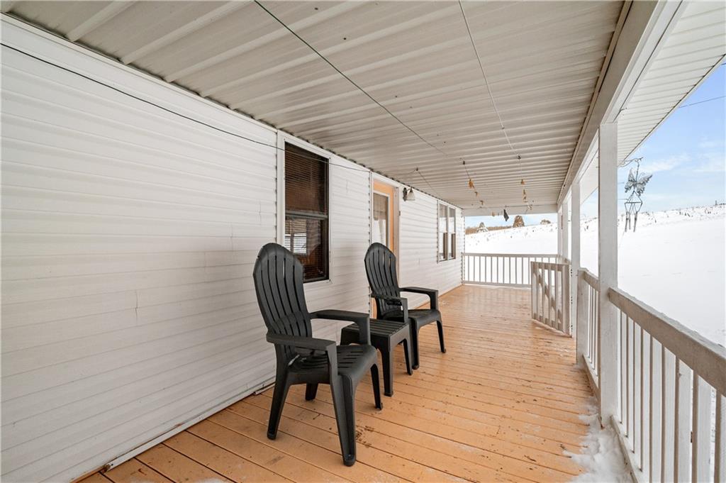 1575 Windows Road Smicksburg, PA 16256 - Photo 9 of 35 a view of a roof deck with table and chairs and wooden floor