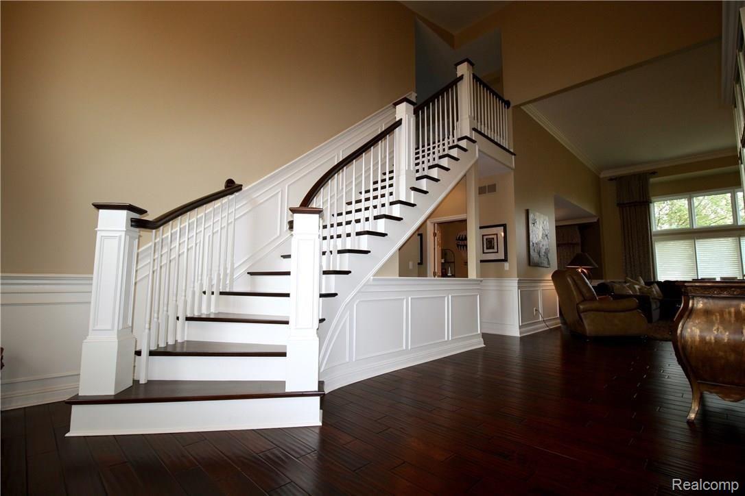 48167 Inveraray Road Canton, MI 48188 - Photo 6 of 37 The custom built stairway makes a grand statement when guests enter the home!