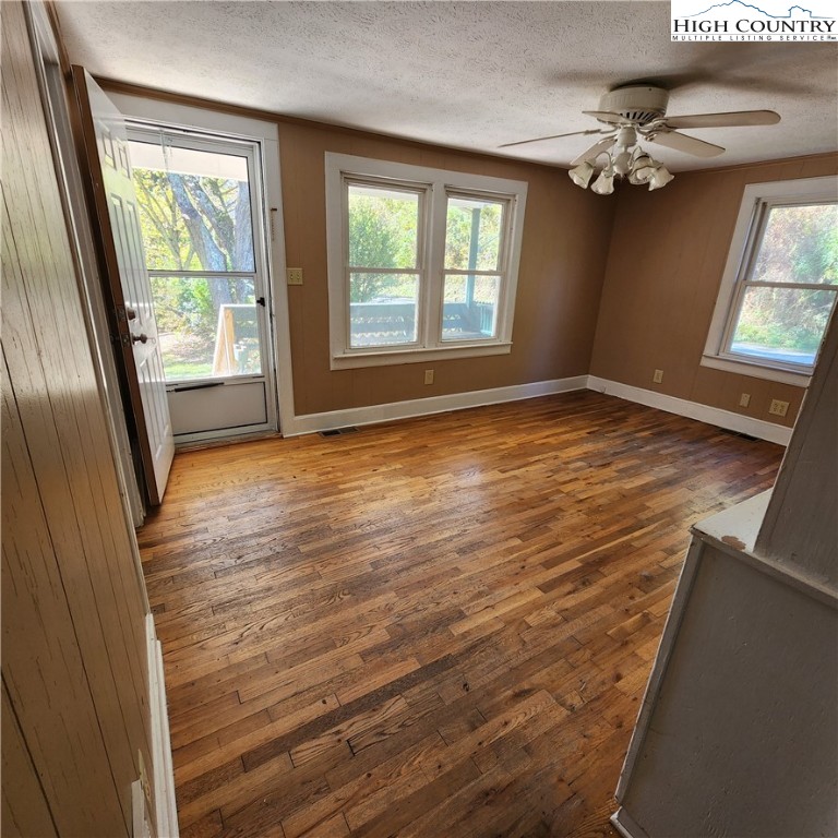 336 Willowdale Church Road Vilas, NC 28692 - Photo 11 of 35 wooden floor in an empty room with a window