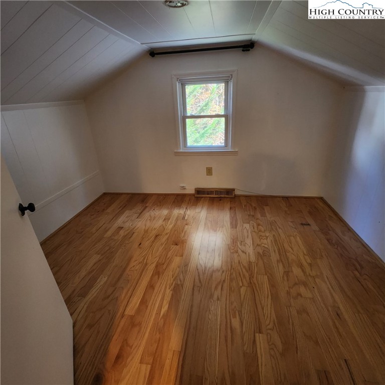 336 Willowdale Church Road Vilas, NC 28692 - Photo 21 of 35 an empty room with wooden floor and windows