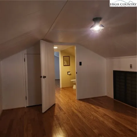 a view of a big room with wooden floor and windows