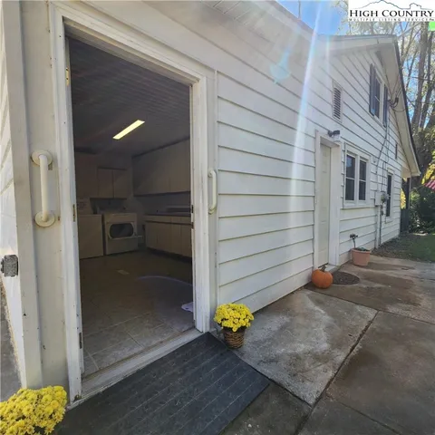 a view of a porch with wooden floor and a potted plant