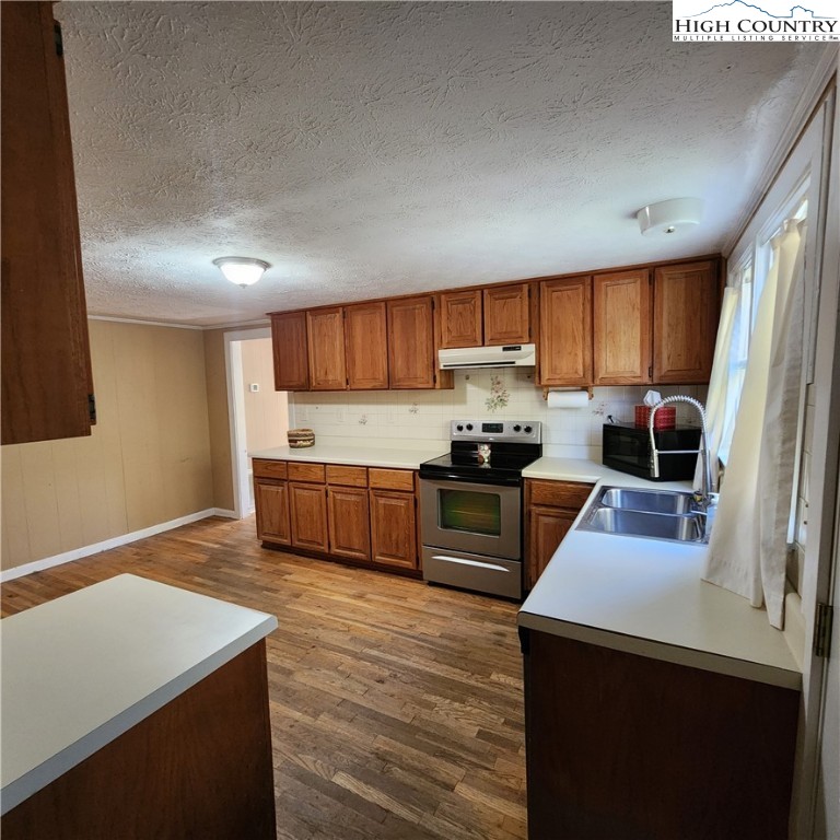 336 Willowdale Church Road Vilas, NC 28692 - Photo 8 of 35 a kitchen with stainless steel appliances a stove a sink a microwave a refrigerator and cabinets