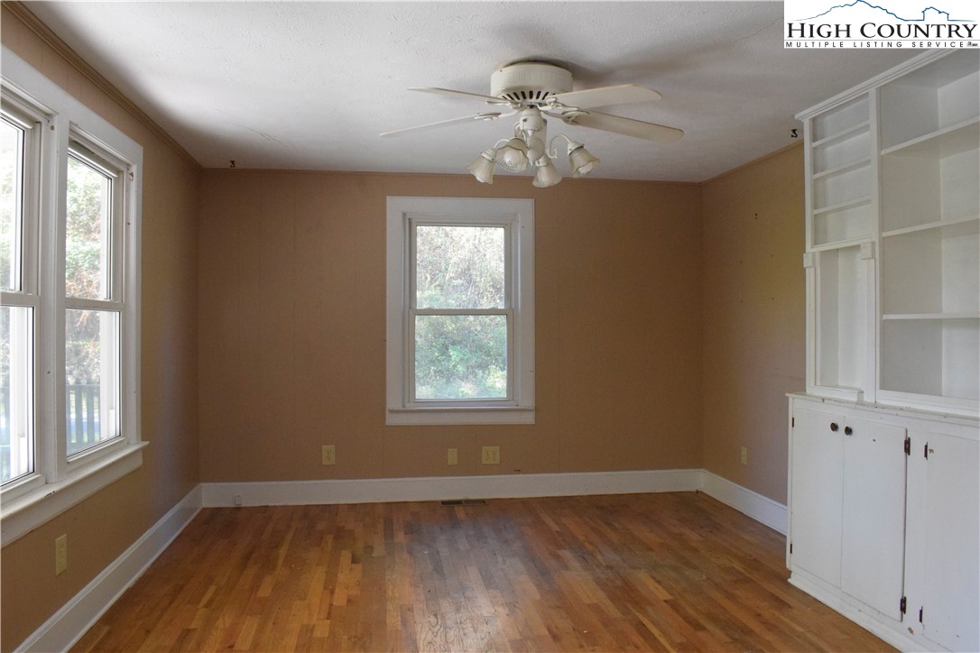 336 Willowdale Church Road Vilas, NC 28692 - Photo 10 of 35 a view of an empty room with wooden floor and a window