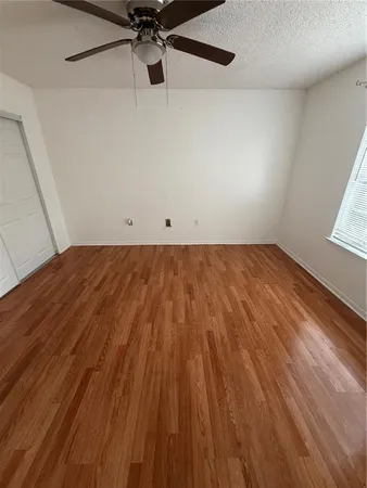 a view of a room with wooden floor