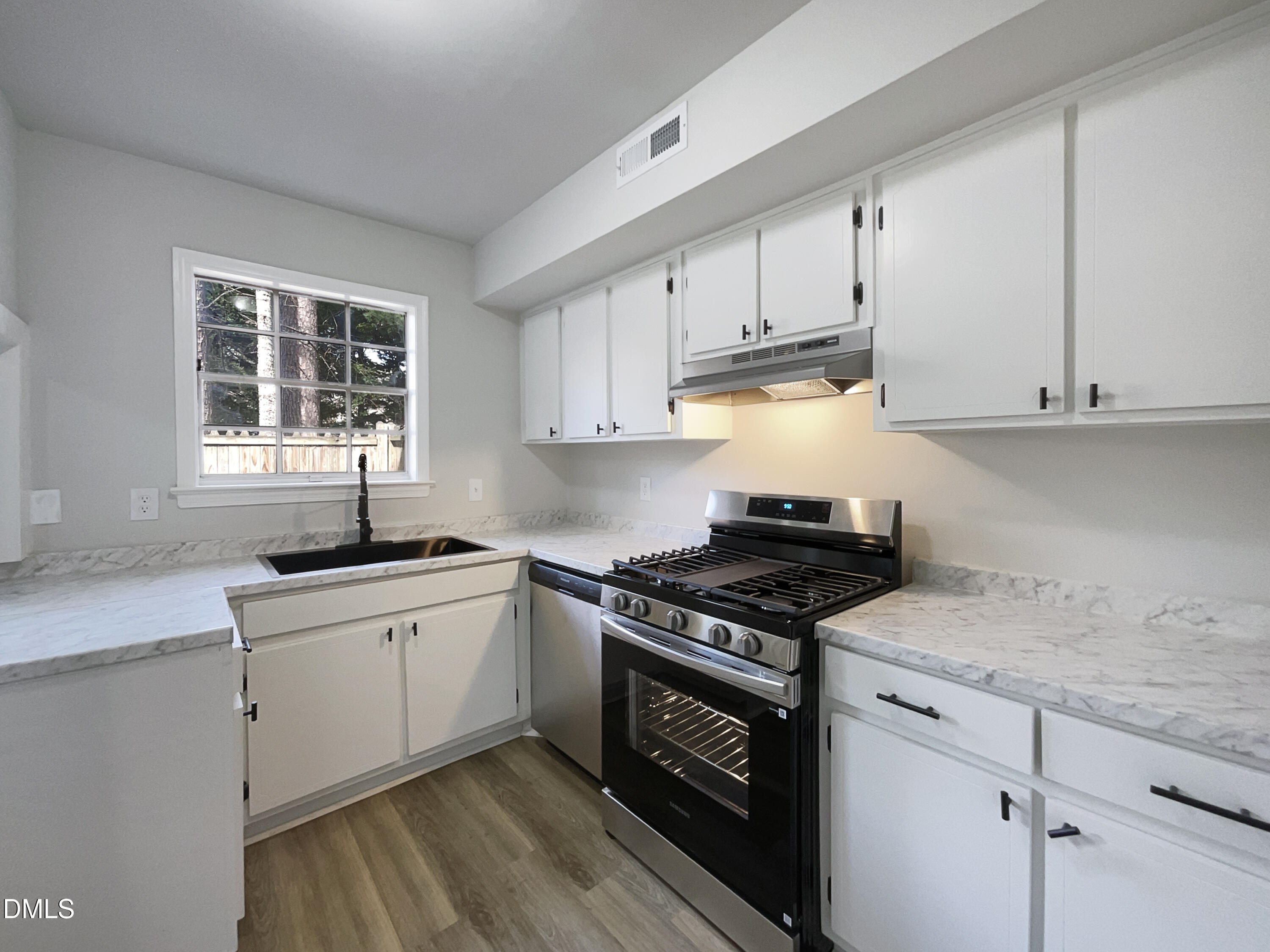 3737 Jamestown Circle Raleigh, NC 27609 - Photo 2 of 14 a kitchen with granite countertop a stove sink and cabinets