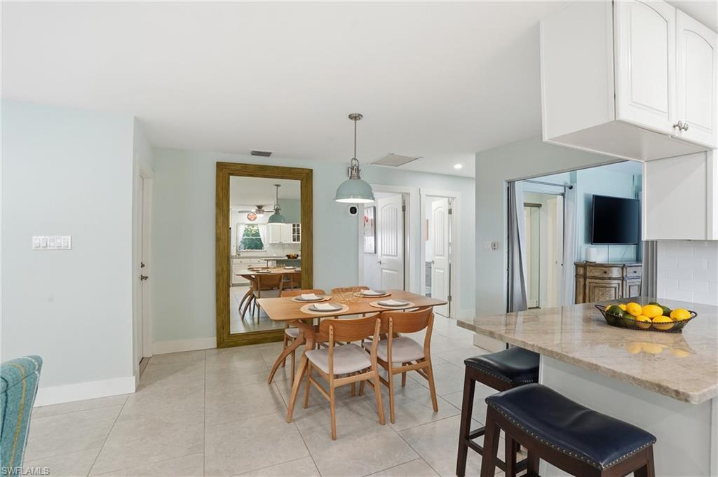 560 109th Avenue North Naples, FL 34108 - Photo 14 of 37 a dining room with furniture and window
