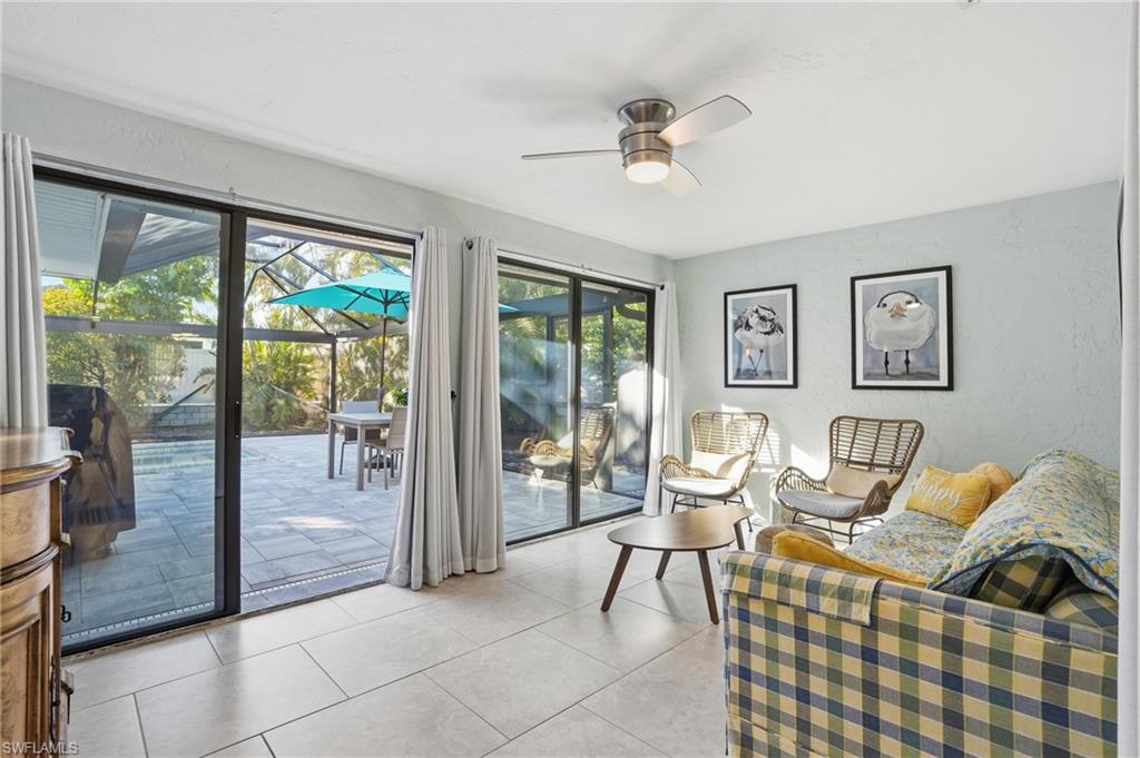 560 109th Avenue North Naples, FL 34108 - Photo 24 of 37 a living room with furniture and a floor to ceiling window