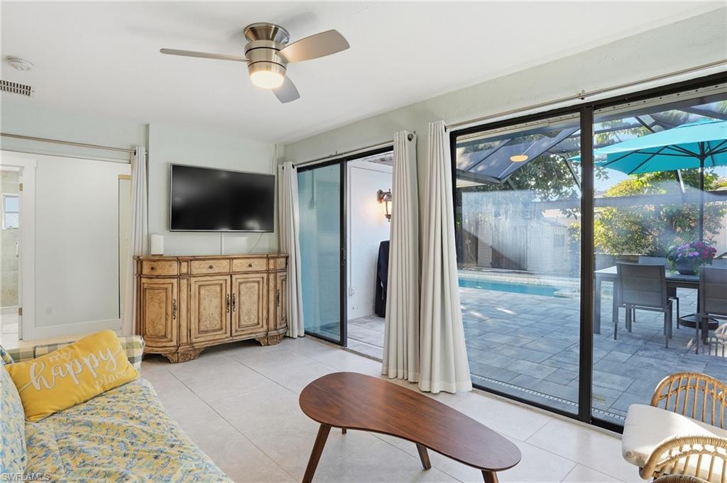560 109th Avenue North Naples, FL 34108 - Photo 25 of 37 a living room with furniture and a flat screen tv