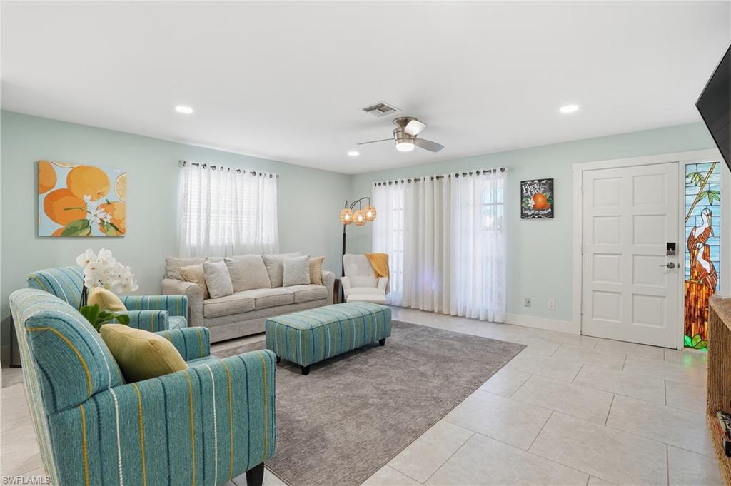 560 109th Avenue North Naples, FL 34108 - Photo 9 of 37 a living room with furniture and wall paintings