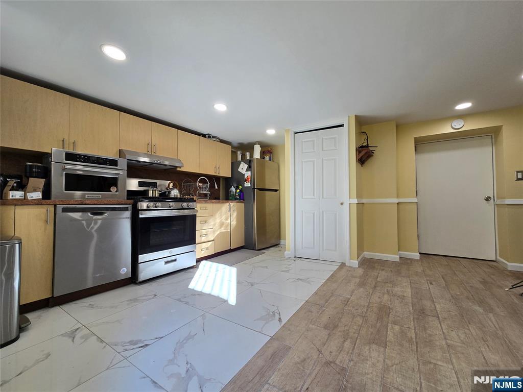 282 Harding Avenue, Unit 1 Teaneck, NJ 07666 - Photo 15 of 21 a view of a kitchen with refrigerator and microwave