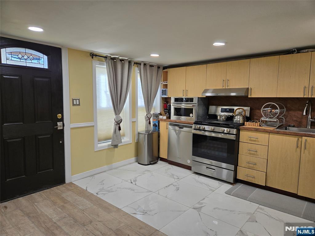282 Harding Avenue, Unit 1 Teaneck, NJ 07666 - Photo 17 of 21 a kitchen with a refrigerator and a sink