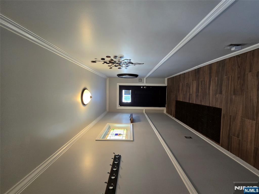 282 Harding Avenue, Unit 1 Teaneck, NJ 07666 - Photo 2 of 21 a view of a hallway with wooden floor and staircase
