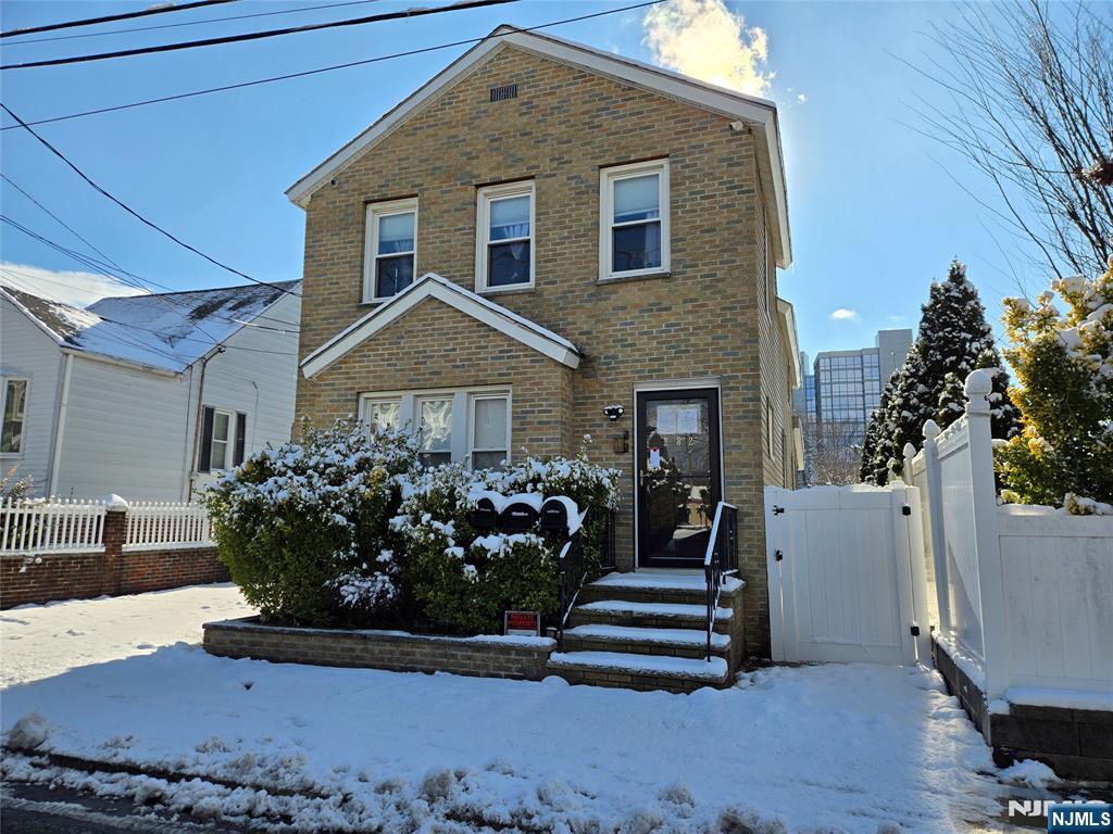 282 Harding Avenue, Unit 1 Teaneck, NJ 07666 - Photo 21 of 21 a front view of a house with a garden