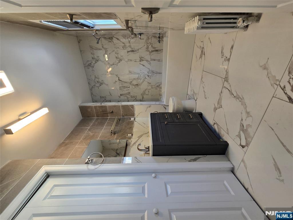 282 Harding Avenue, Unit 1 Teaneck, NJ 07666 - Photo 7 of 21 a bathroom with a bathtub and shower