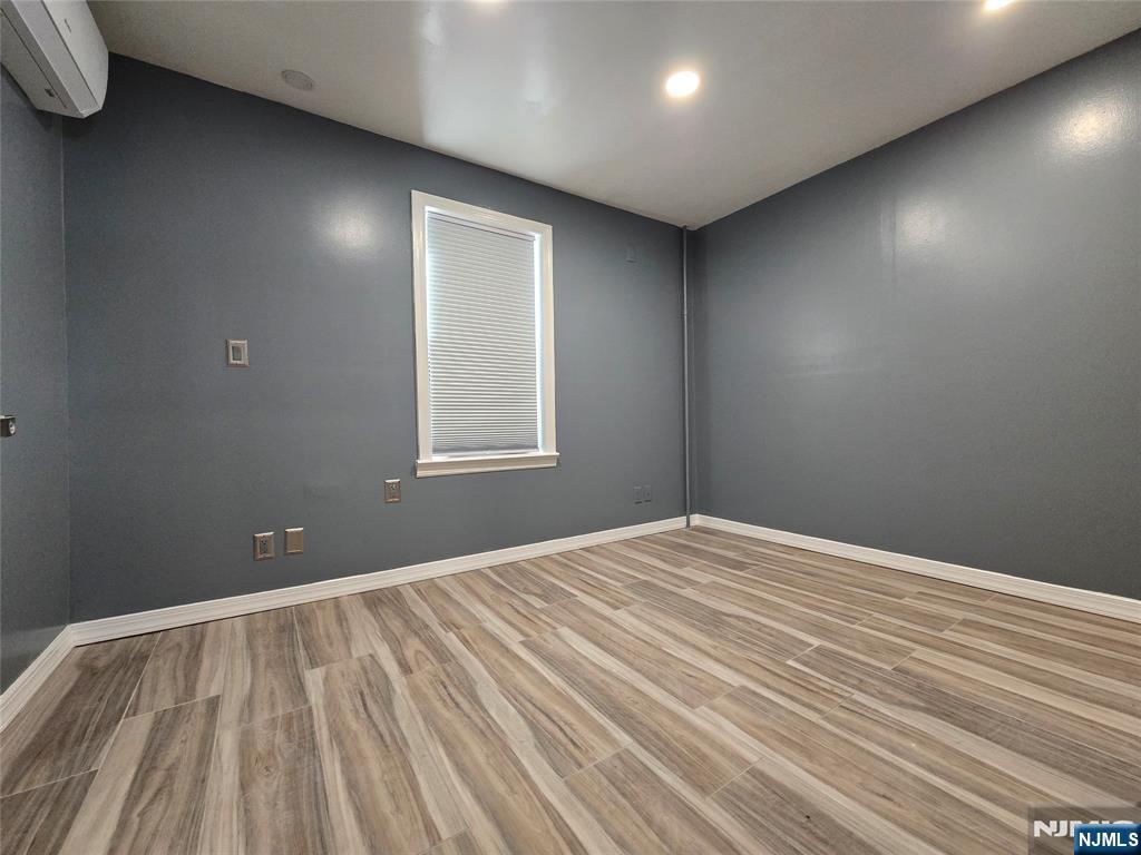 282 Harding Avenue, Unit 1 Teaneck, NJ 07666 - Photo 9 of 21 a view of empty room with wooden floor