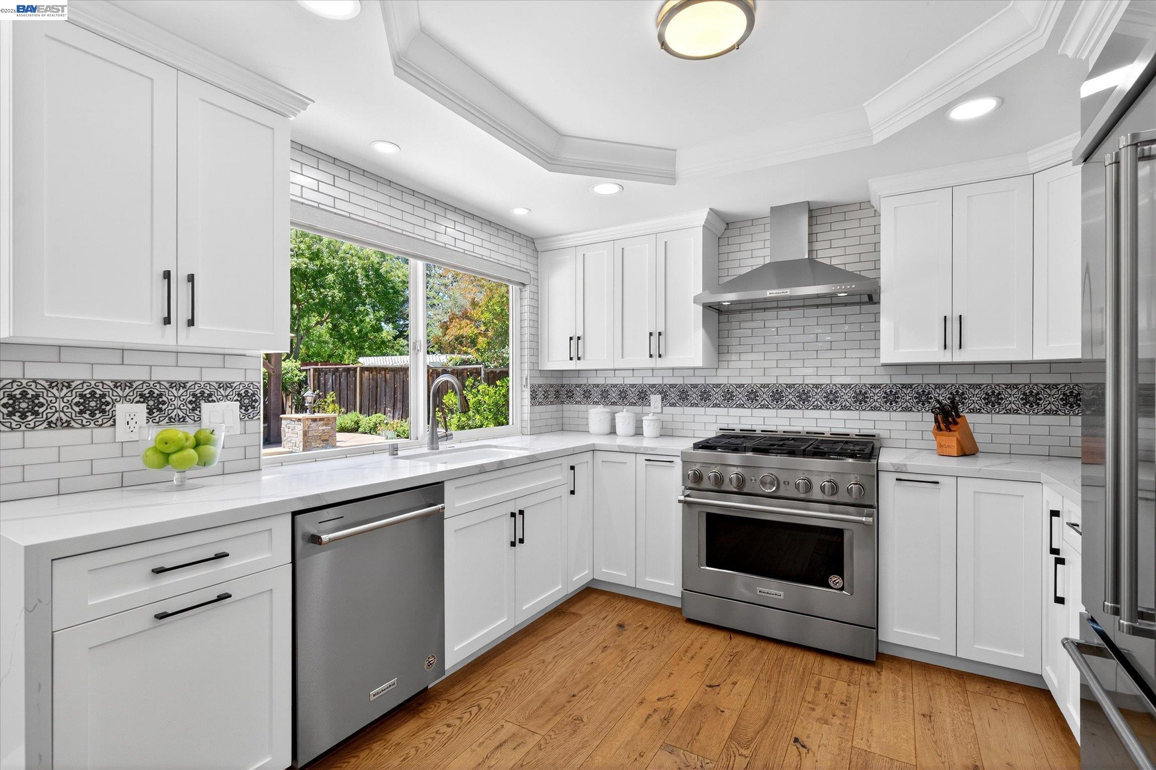 515 Burns Circle San Ramon, CA 94583 - Photo 15 of 49 a kitchen with stainless steel appliances granite countertop a stove a sink dishwasher and white cabinets with wooden floor
