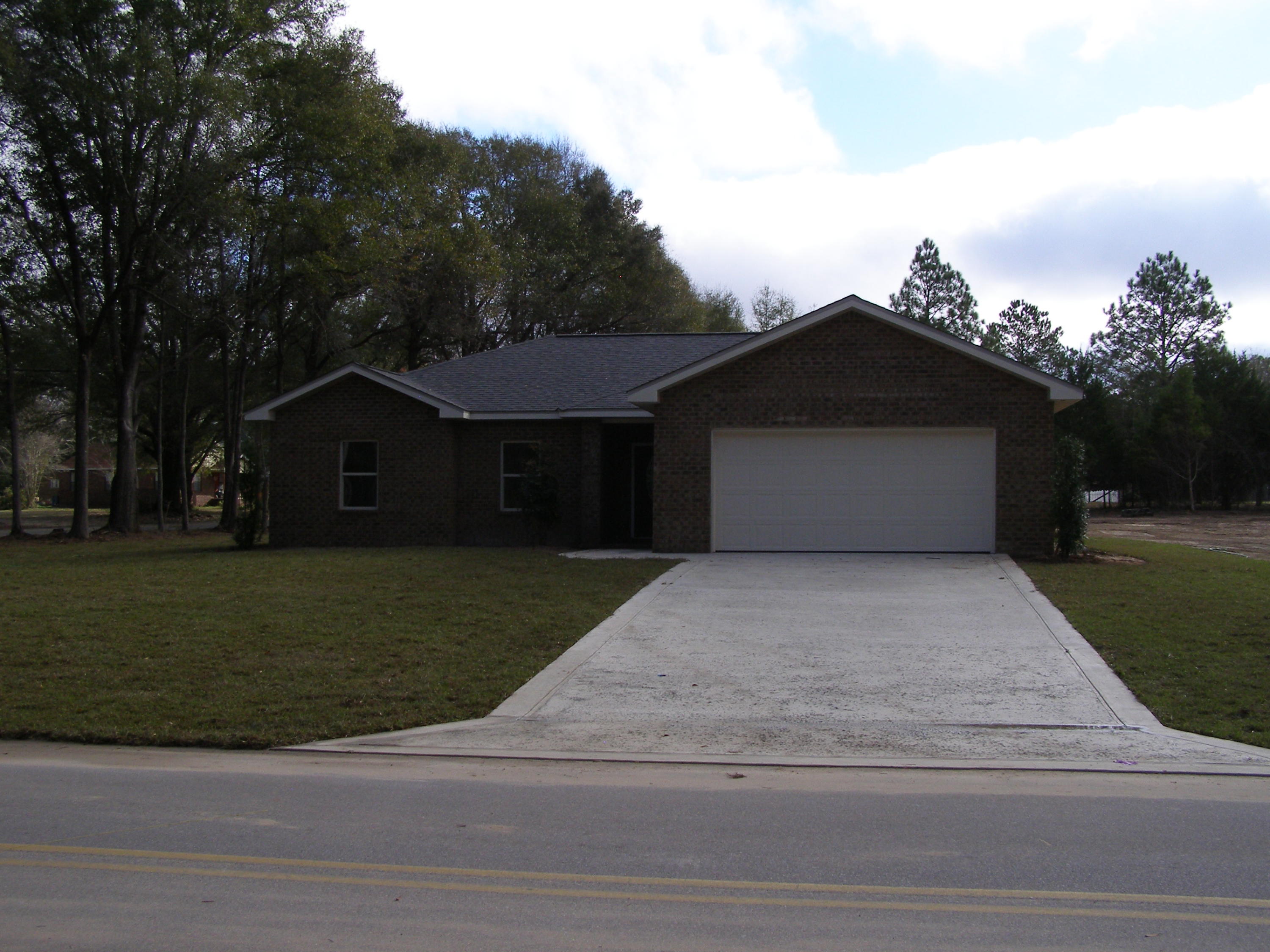 771 Ridge Lake Road Crestview, FL 32536 - Photo 1 of 19 a front view of a house with a garden