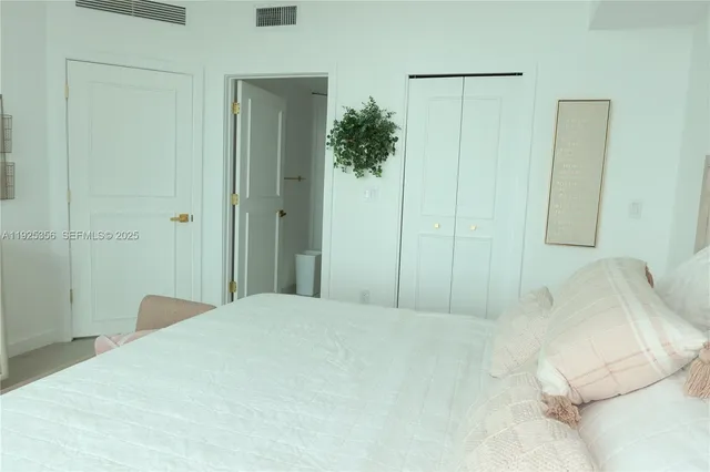 a bedroom with a bed and a mirror