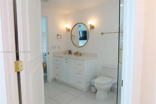 a bathroom with a toilet a sink and a mirror