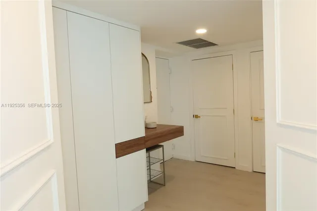 a view of a hallway with seating area