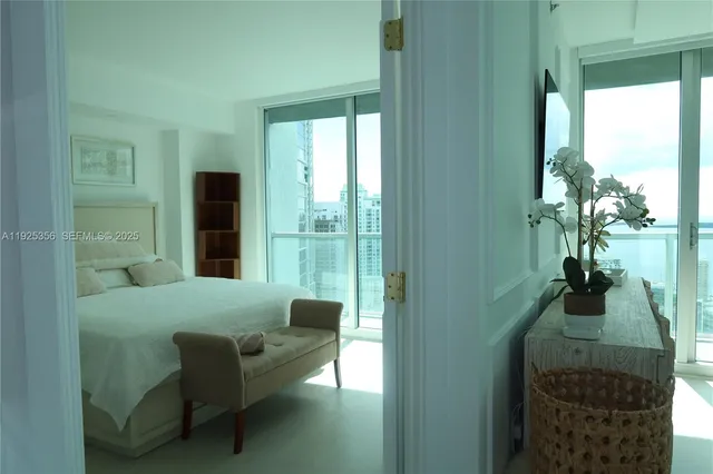 a living room with furniture and a floor to ceiling window