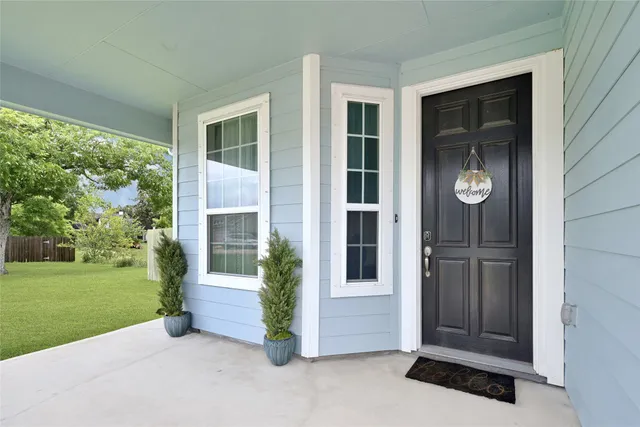a view of porch with a door and chair