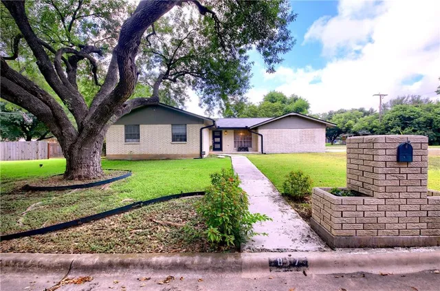 a front view of a house with garden