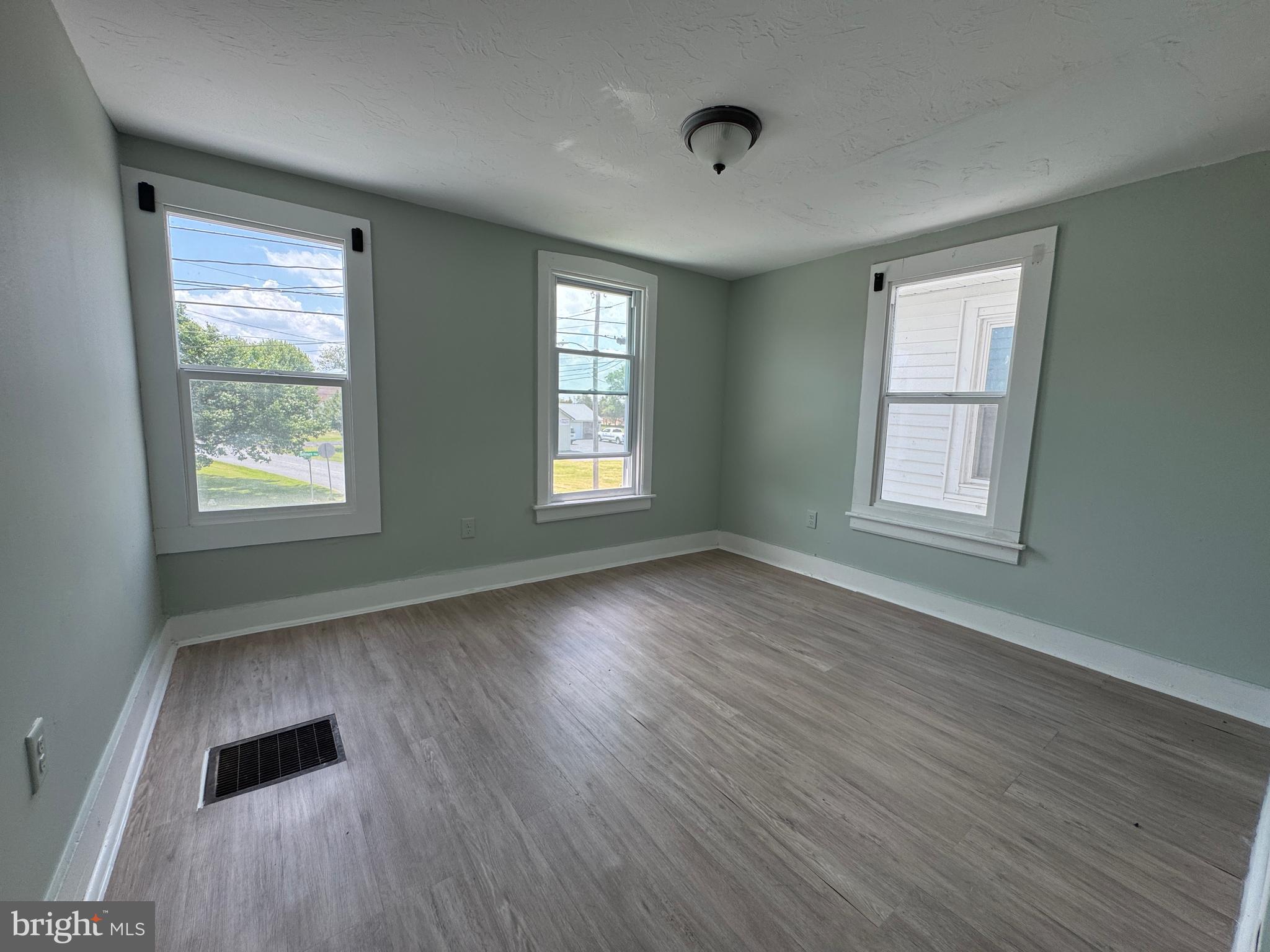 3754 Baltimore Pike, Unit 3 Littlestown, PA 17340 - Photo 14 of 21 a view of an empty room with wooden floor and a window