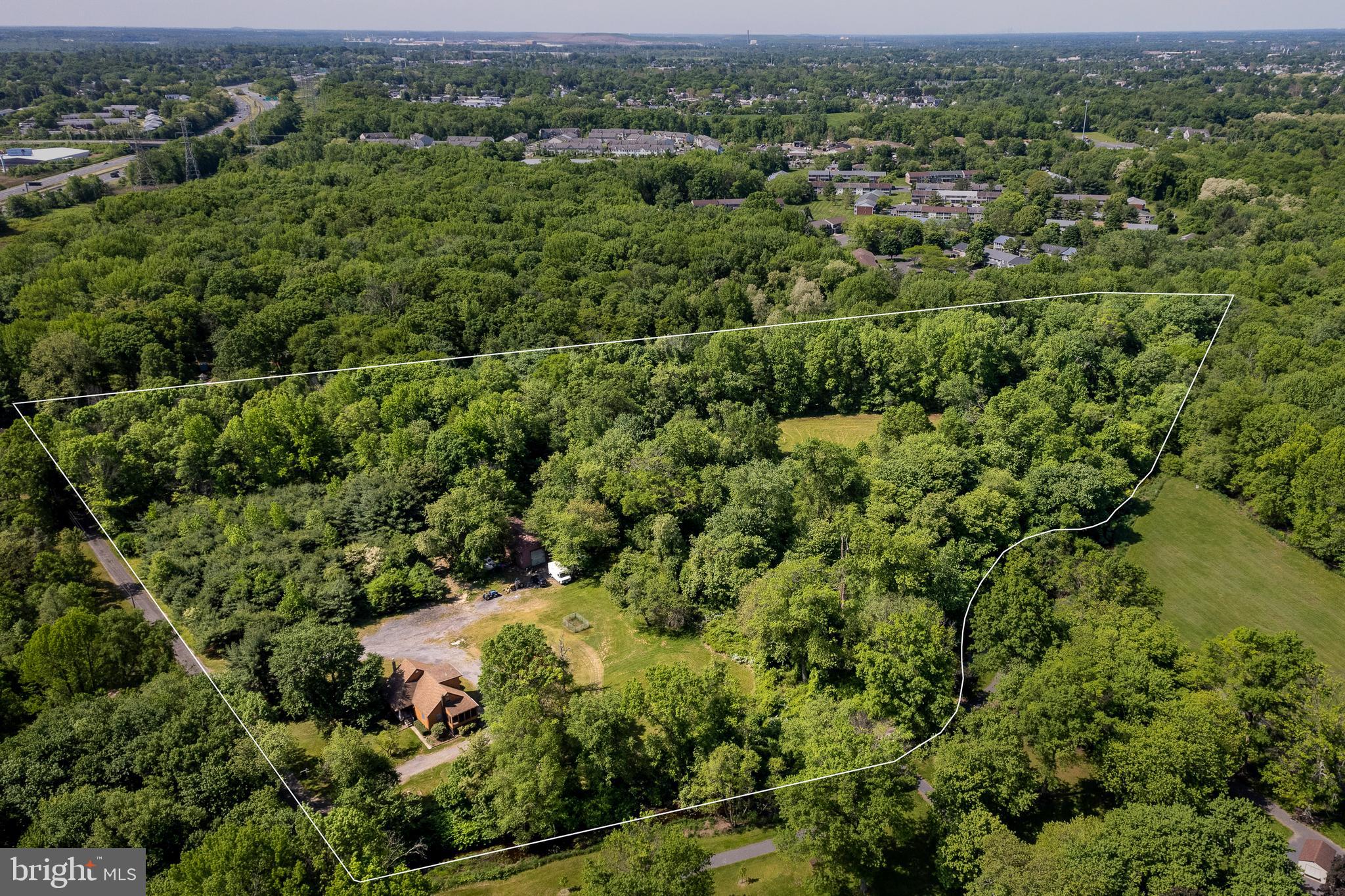 an aerial view of a forest with houses