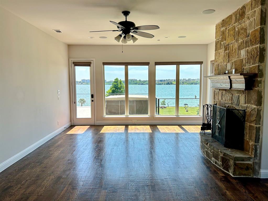 2313 Windjammer Way Rowlett, TX 75088 - Photo 8 of 38 a view of an empty room with a fireplace and a window