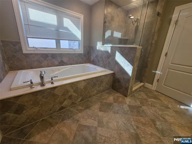 a bath tub sitting next to a bathroom sink