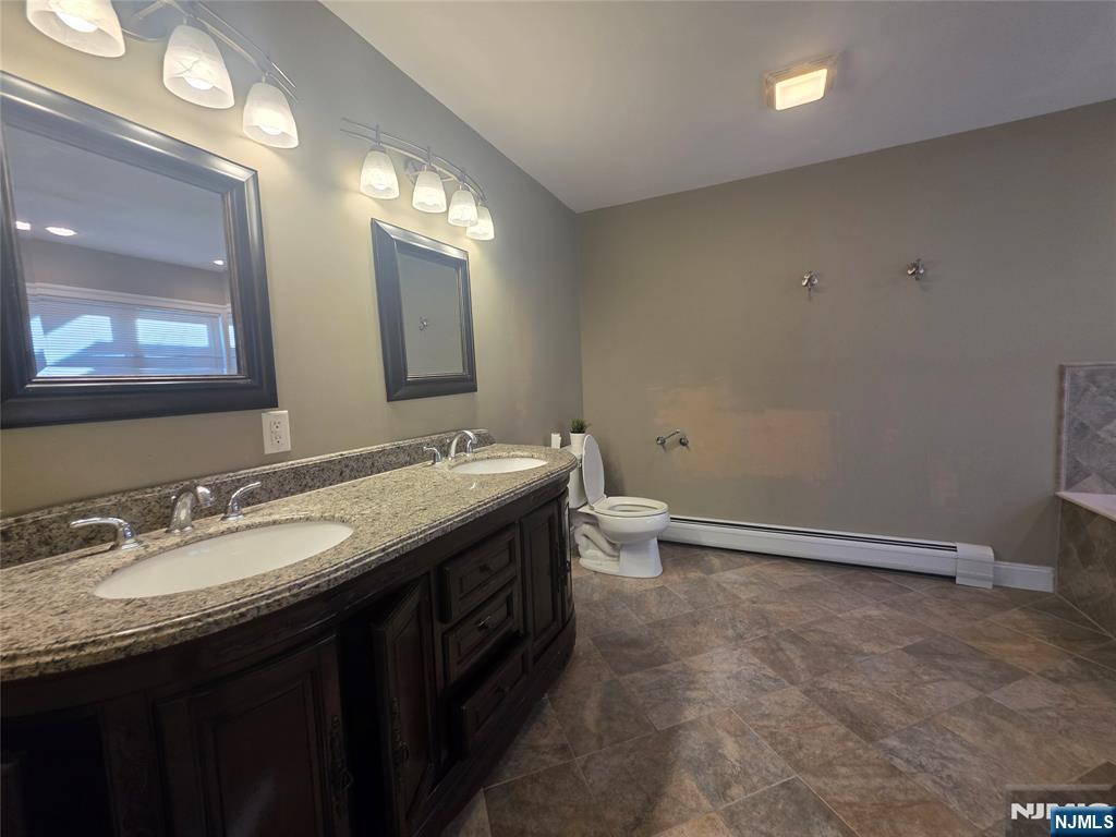 336 Roff Avenue, Unit A Palisades Park, NJ 07650 - Photo 8 of 9 a bathroom with a granite countertop sink a toilet and a mirror