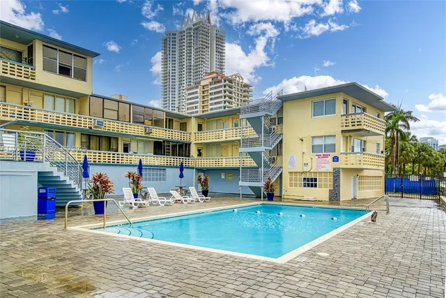 a view of building with a swimming pool