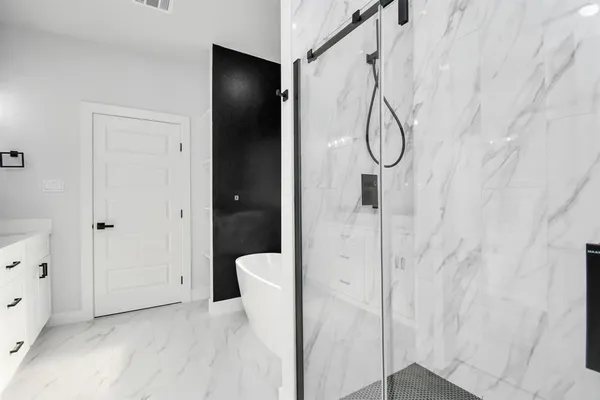 a bathroom with a glass shower door