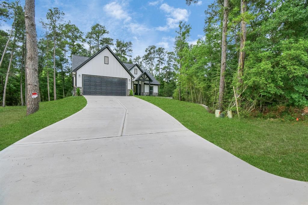12163 La Salle River Road Conroe, TX 77304 - Photo 2 of 27 a front view of a house with yard