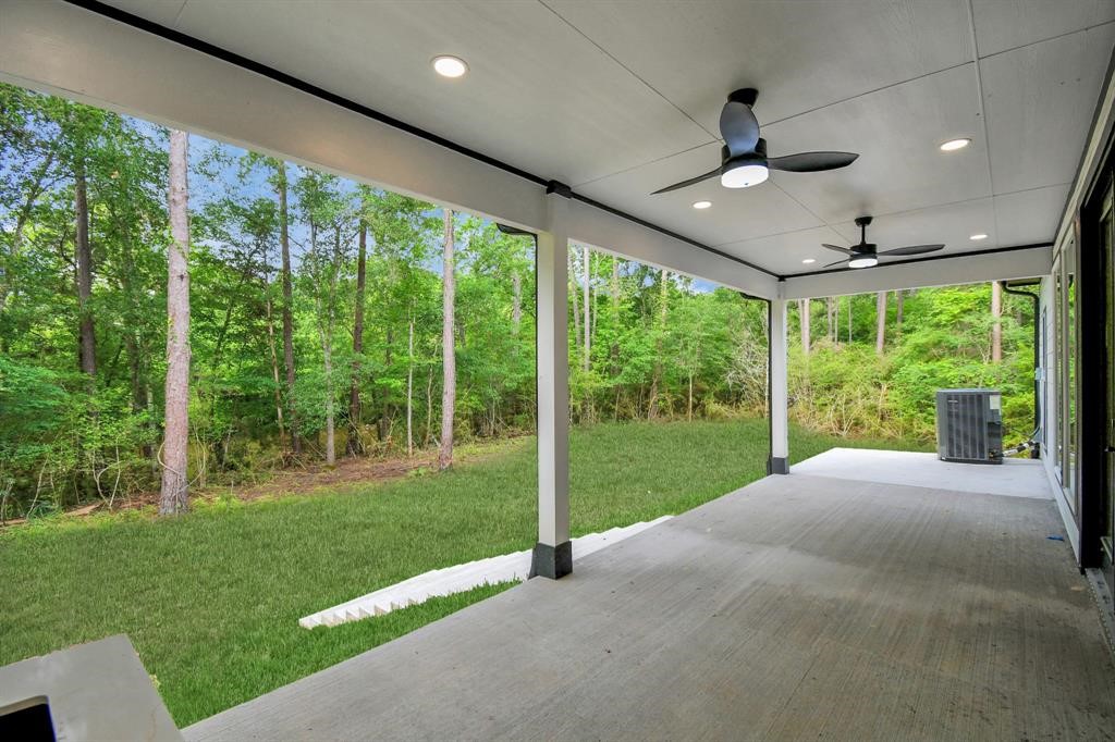12163 La Salle River Road Conroe, TX 77304 - Photo 25 of 27 a view of a porch in front of a big yard with wooden fence