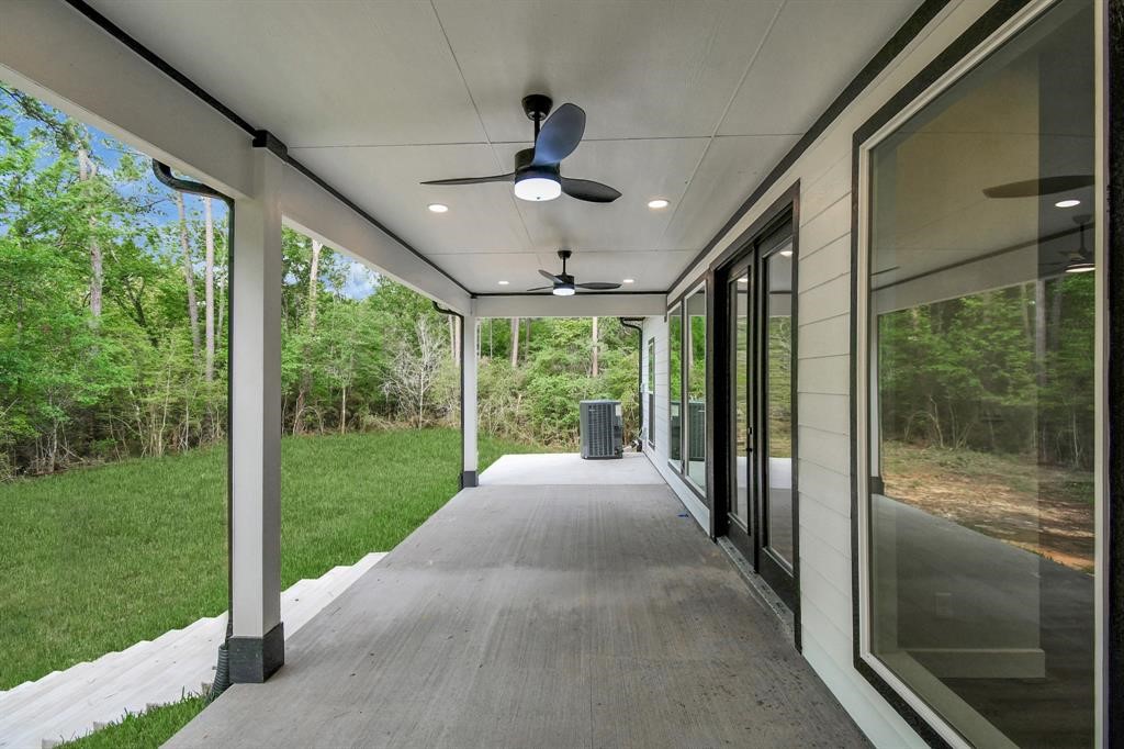 12163 La Salle River Road Conroe, TX 77304 - Photo 26 of 27 a view of a porch in front of a house with a big yard