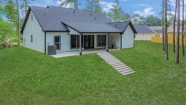 a front view of a house with a garden and yard