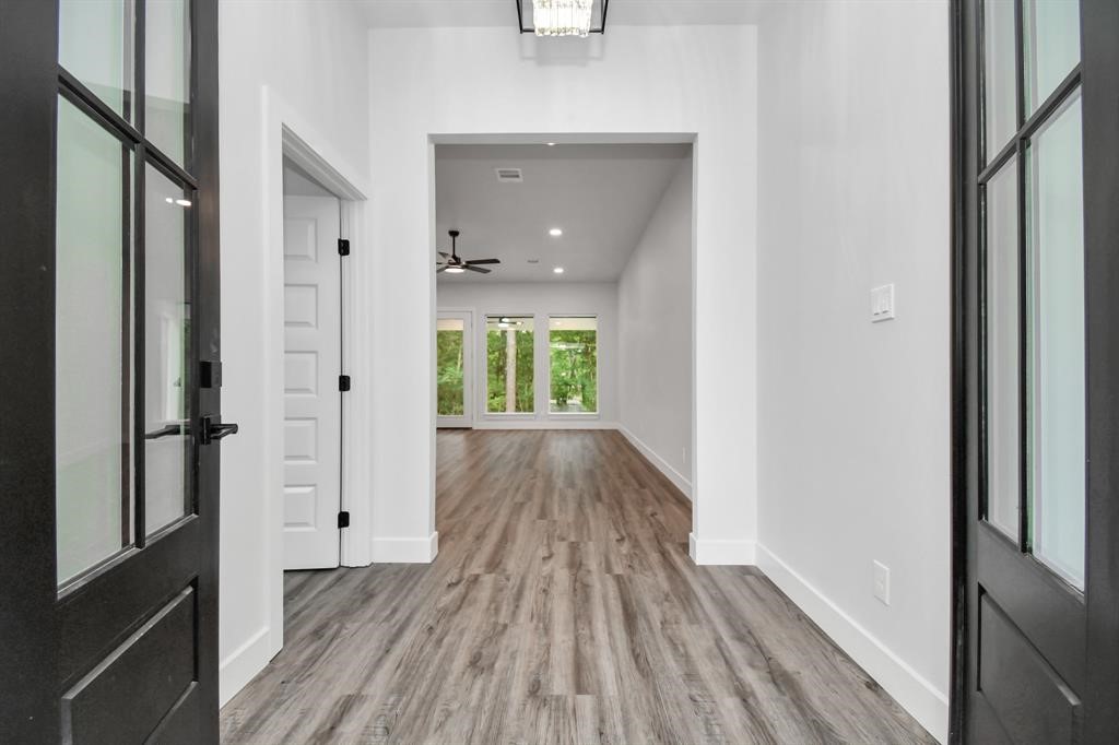 12163 La Salle River Road Conroe, TX 77304 - Photo 3 of 27 a view of a hallway view with wooden floor and staircase