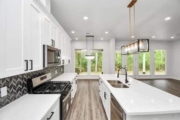 a kitchen with a large window in it and kitchen island