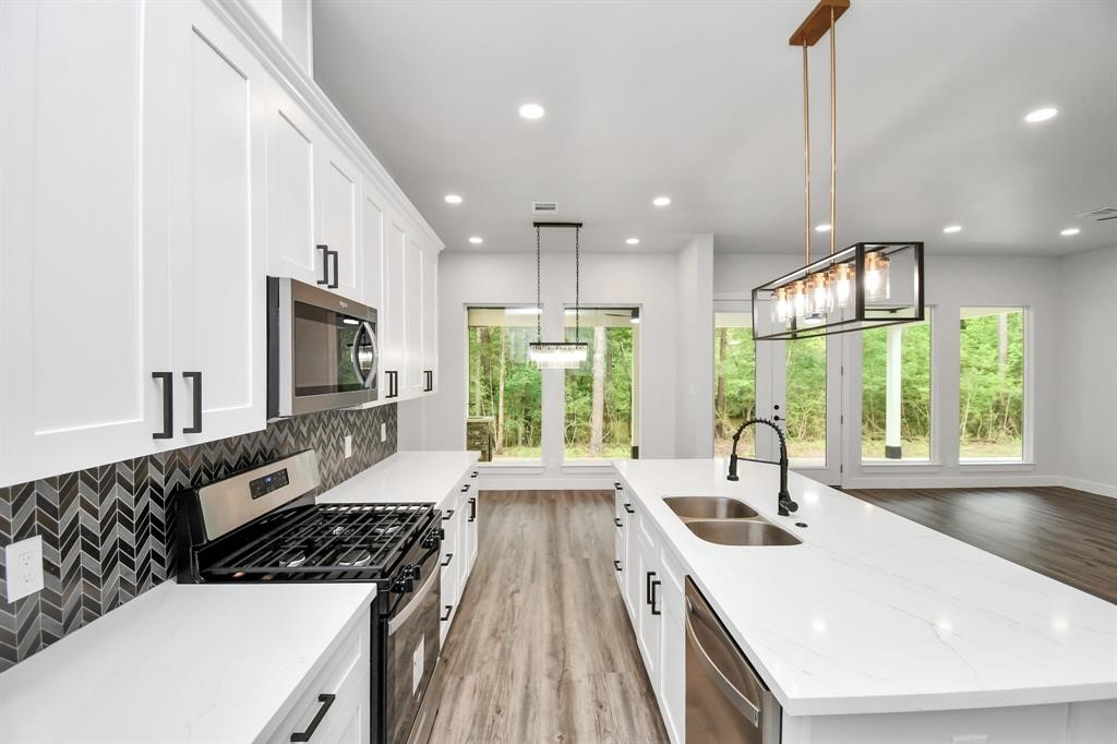 12163 La Salle River Road Conroe, TX 77304 - Photo 4 of 27 a kitchen with a large window in it and kitchen island