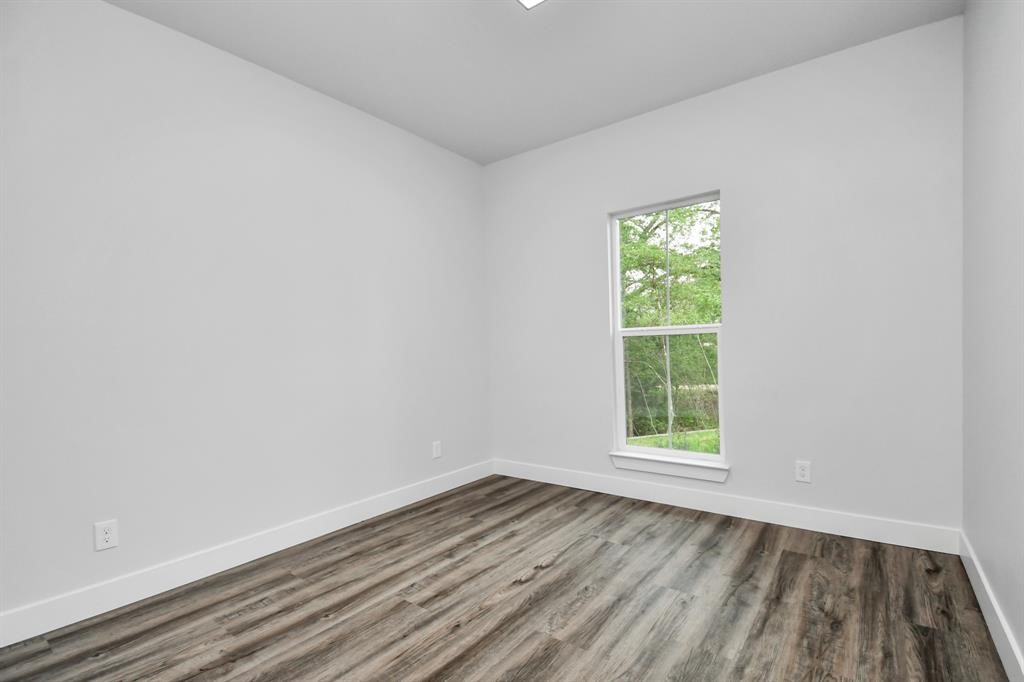 12163 La Salle River Road Conroe, TX 77304 - Photo 7 of 27 an empty room with wooden floor and windows