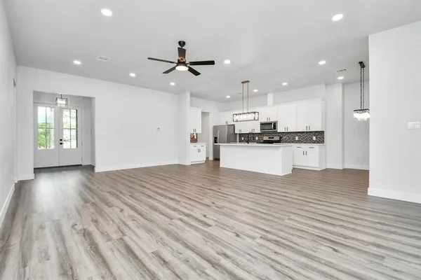 a view of kitchen with cabinets and wooden floor