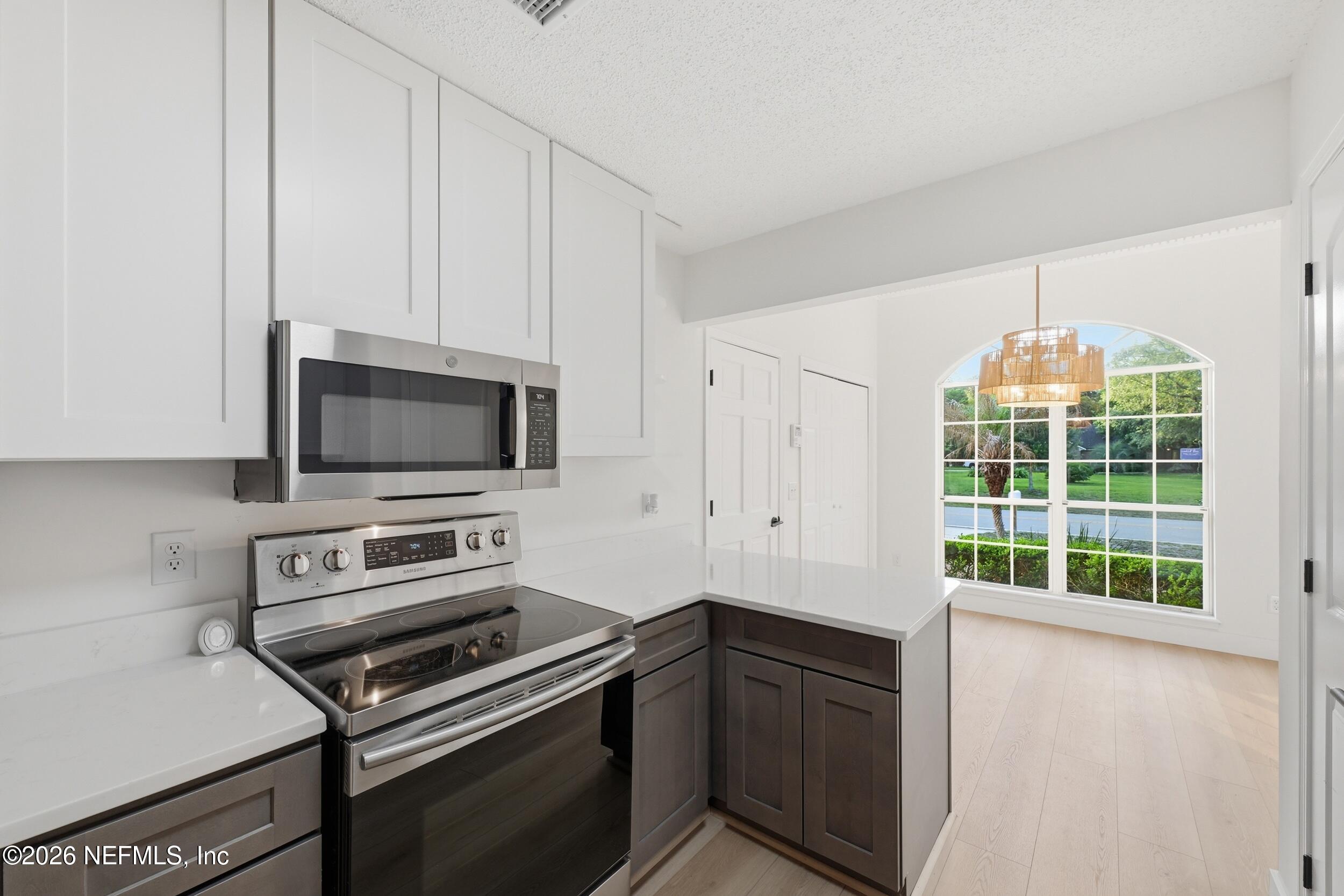 3286 Marbon Road Jacksonville, FL 32223 - Photo 15 of 36 a kitchen with a stove and a microwave