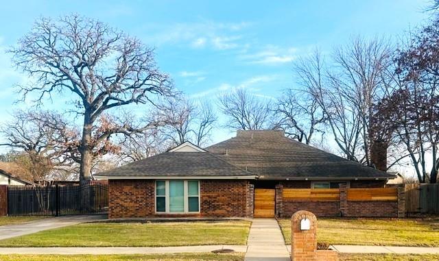 2109 Oakmeadow Street Bedford, TX 76021 - Photo 1 of 31 View of front of house featuring a fenced front yard, brick siding, and a gate