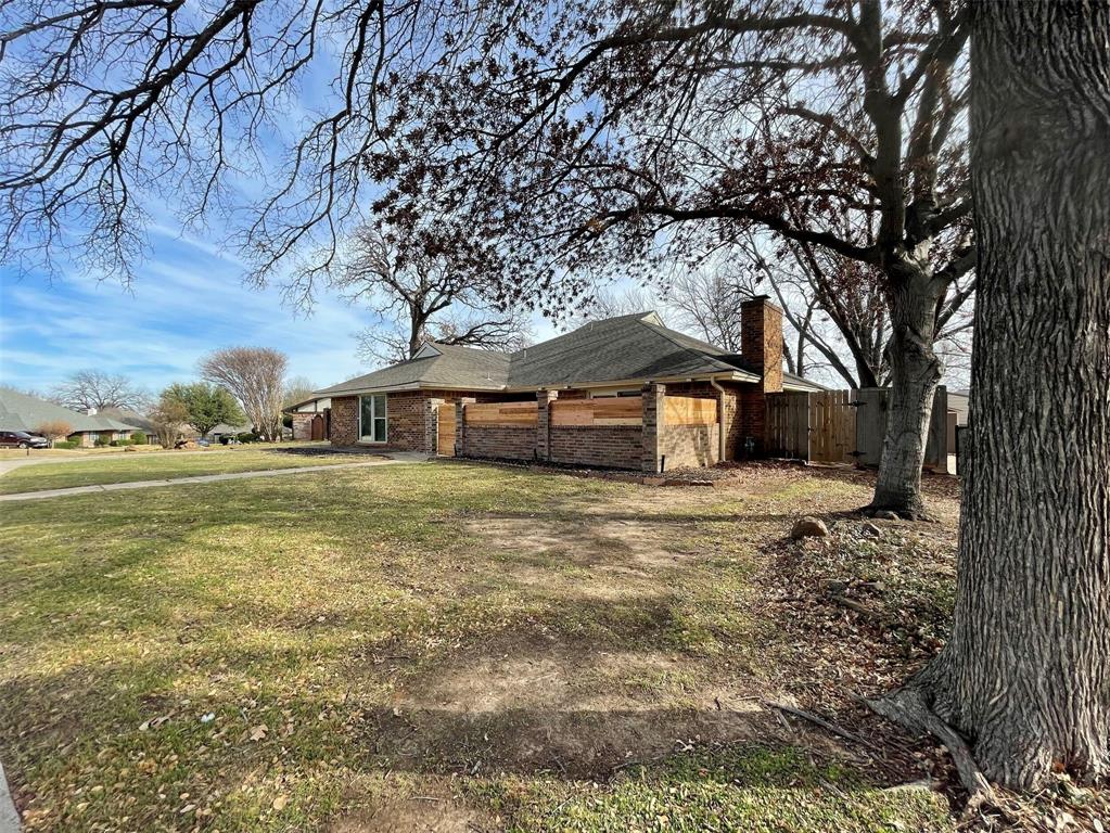 2109 Oakmeadow Street Bedford, TX 76021 - Photo 28 of 31 View of side of home featuring brick siding and a chimney